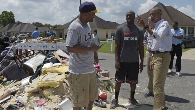 President Barack Obama talks with a local resident while touring Castle Place, a flood-damaged area of Baton Rouge, Louisiana.