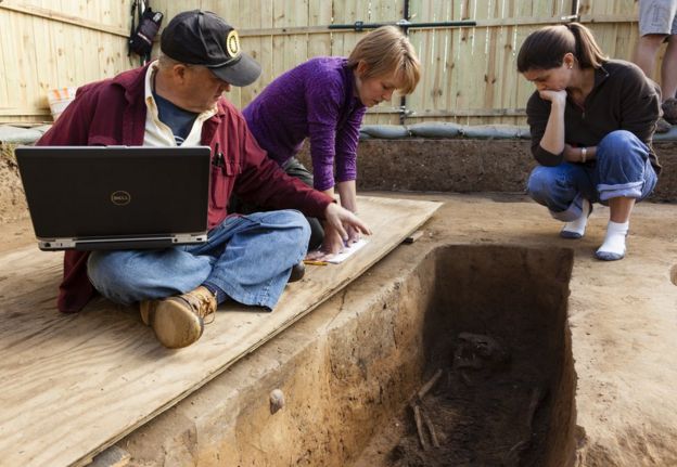 Forensic anthropologist examine the grave of Rev Robert Hunt