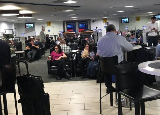 Passengers wait at LaGuardia Airport, New York