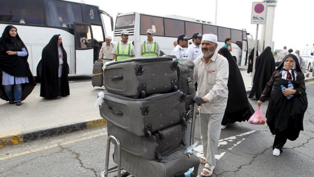 An Iranian pilgrim (C) returns from Saudi Arabia