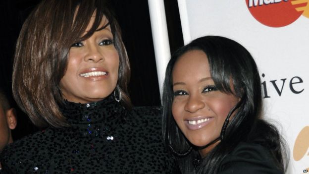 Singer Whitney Houston and daughter Bobbi Kristina Brown arrive at an event in Beverly Hills, California. Feb 2011.