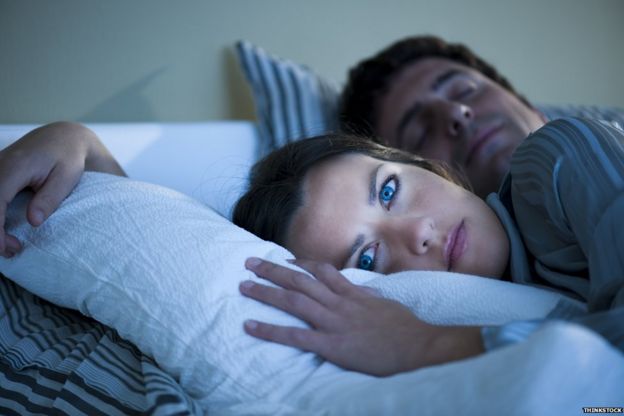 Woman awake in bed