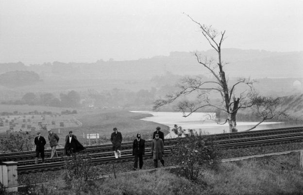 Police search a stretch of railway tracks
