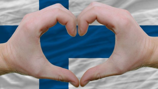 Bandera y gesto de corazón.