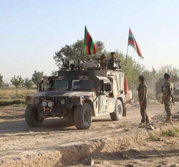 Afghan national army stand guard in front of the main prison building after the attack