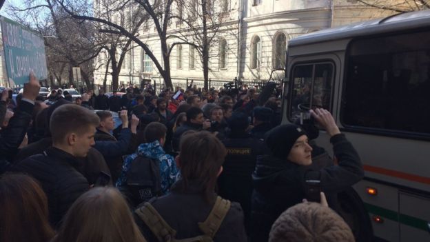 In this handout photo provided by Kira Yarmysh, Alexei Navalny press secretary, people block the way for police bus, where Alexei Navalny is kept in downtown Moscow