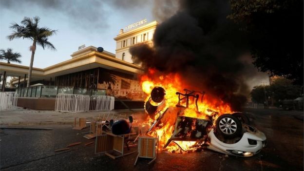A car is seen on fire outside the O'Higgins hotel in Viña del Mar