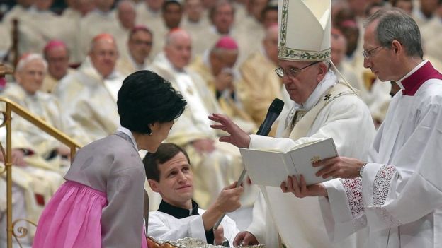 Pope Francis baptises Stella Hee Kim (L) of South Korea during the Easter Vigil mass at the Saint Peter