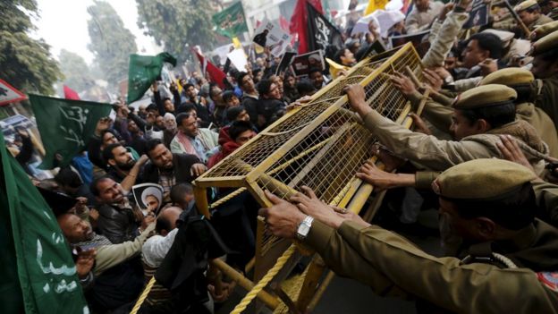Shia Muslims push barricades installed by police during a protest against the execution of cleric Nimr al-Nimr in front of Saudi Arabia embassy in New Delhi, India, on Monday 4 January 2016