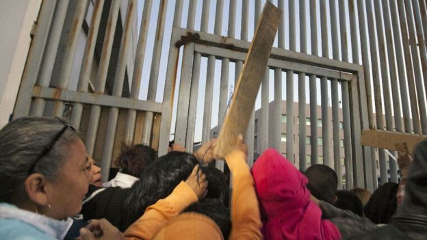 Sticks thrown at gate outside Topo Chico prison. 11 Feb 2016