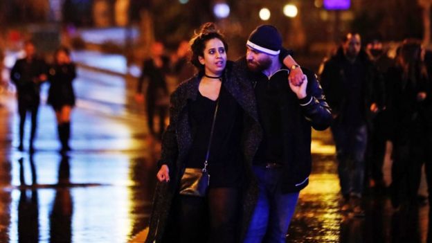 Young people leave from the scene of an attack in Istanbul, early Sunday