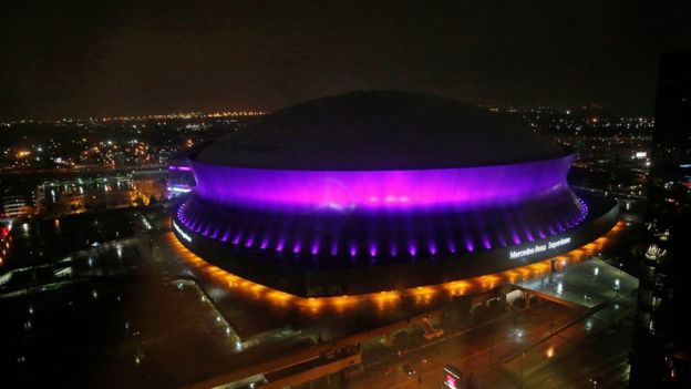 The Mercedes-Benz Superdome is lit up in the color purple in New Orleans, 21 April 2016, to honour Prince