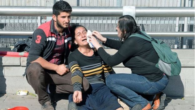 A woman is helped following an explosion in Turkey's capital Ankara (10 October 2015)