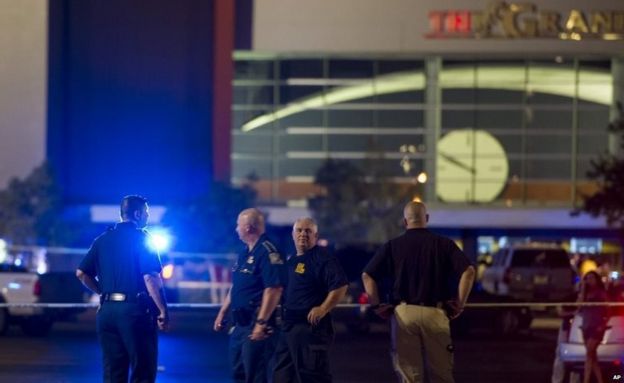 Law enforcement personnel stand near a police line at The Grand Theatre following a deadly shooting in Lafayette, La., 23 July 2015.