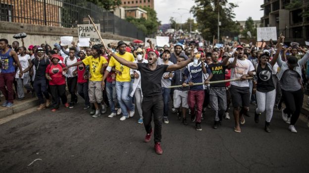 Students march through the campus of the University of the Witwatersrand in Johannesburg on October 21, 2015, during a protest against fee hikes. Universities in Cape Town, Johannesburg, Pretoria and other cities have halted lectures during several days of protests against fee increases that many students say will force poor blacks further out of the education system.
