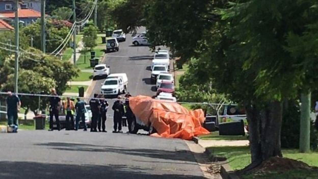 Scene from Camp Hill in Brisbane with police waiting around a cordon at the site of a car fire