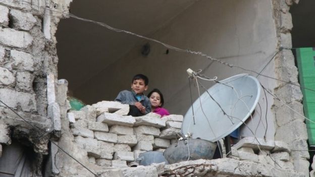 Children in partly destroyed building in Aleppo