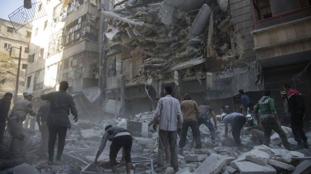 Syrian civilians and rescuers search for survivors following air strikes in the rebel held neighbourhood of Al-Shaar in Aleppo, 27 September 2016