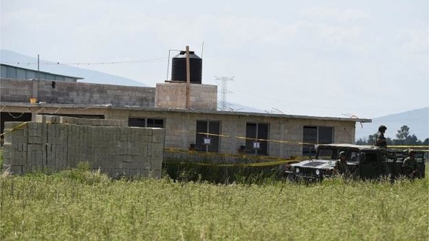 Military and police personnel patrol the house where the tunnel through which Mexican drug lord Joaquin 'El Chapo' Guzman escaped from the Altiplano prison ended, in Almoloya de Juarez, Mexico, on 13 July, 2015