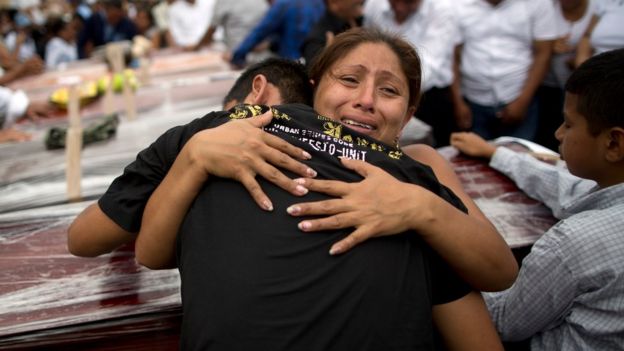 Relatives mourn the loss of their family members, victims of the 7.8-magnitude earthquake, during a funeral service in Portoviejo, Ecuador, Monday, April 18, 2016