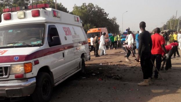 People clearing the scene after suicide attack in Maiduguri, Nigeria