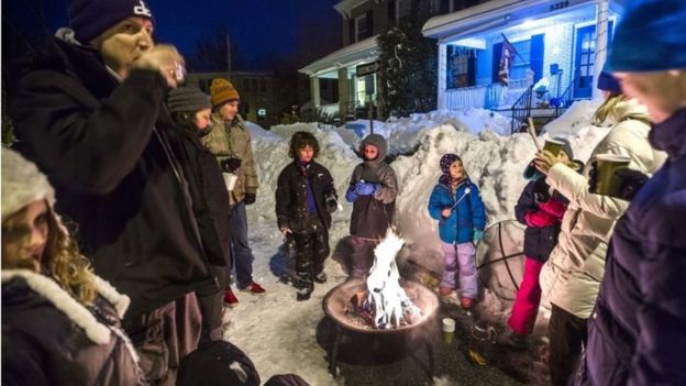 Residents of Belt Road in Washington DC gather by a bonfire. Photo: 24 January 2016