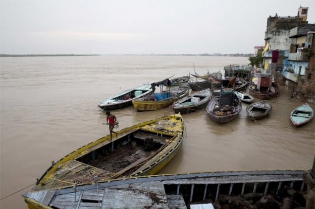 In this Friday, Aug. 26, 2016 photo, boats are docked at the Manikarnika Ghat, submerged by the flood waters in Varanasi, India.
