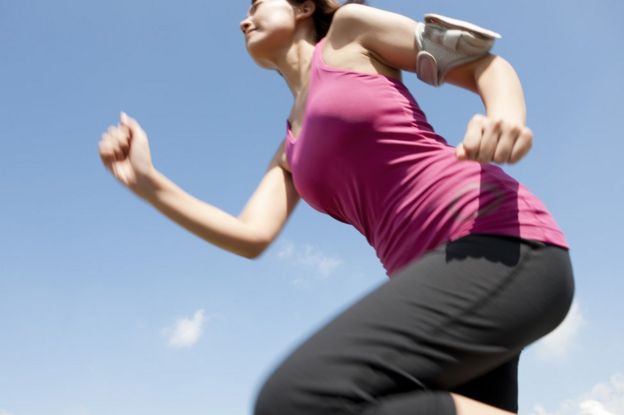 Woman jogging wearing armband