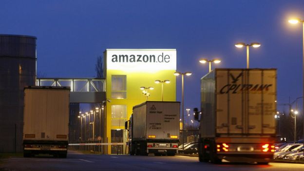 Trucks drive into the online retailer Amazon's distribution centre in the eastern German city of Leipzig