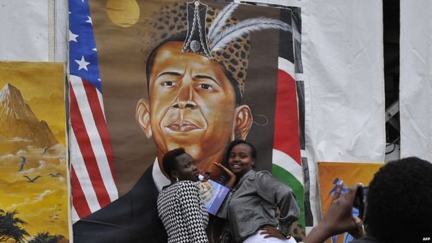 Kenyan women pose for a photograph in front of a painted artwork depicting US President Barack Obama, on July 23, 2015 at the Pre-Global Entrepreneurship Summit in Nairobi,