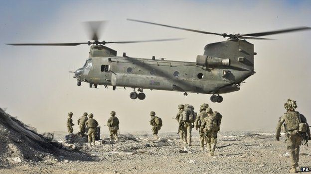 British soldiers approach a Chinook helicopter in Helmand Province, Afghanistan
