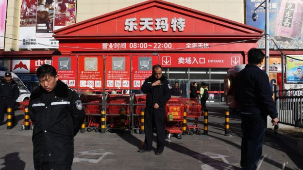 Policemen patrol outside a Lotte Mart in Beijing on March 9, 2017.