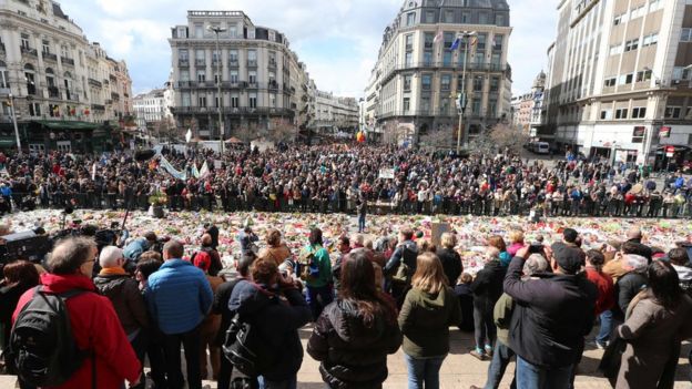 March goes past the makeshift memorial in the Stock Exchange Square, Brussels, on 17 April 2016