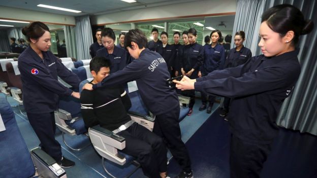 Korean Air crew practice using electric stun guns