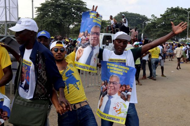 Supporters of Evaristo Carvalho wearing T-shirts and holding placards picturing the politician celebrate in Sao Tome, 18 July