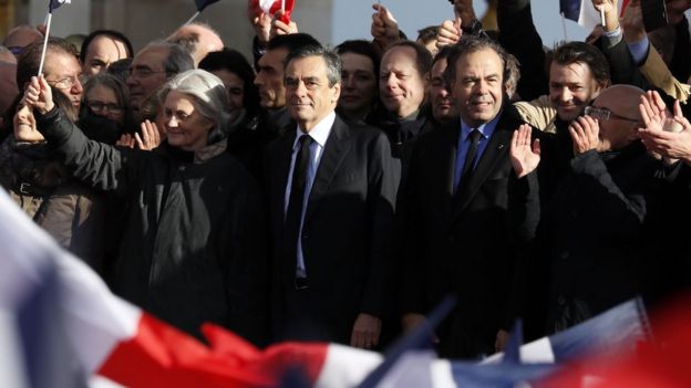 Mr Fillon (C) with Penelope (L) and other senior supporters at the podium