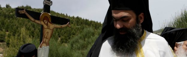 Greek Orthodox priests take part in a Good Friday re-enactment on 29 April