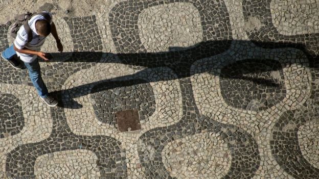 A man walks with his mobile phone in his hand in downtown Rio de Janeiro, Brazil