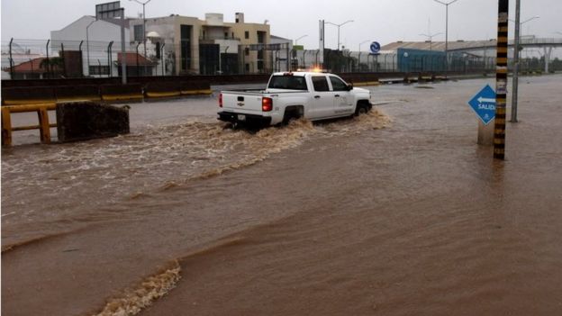 A truck drives along a flooded street in Manzanillo, Colima state, Mexico on October 23, 2015, during hurricane Patricia.