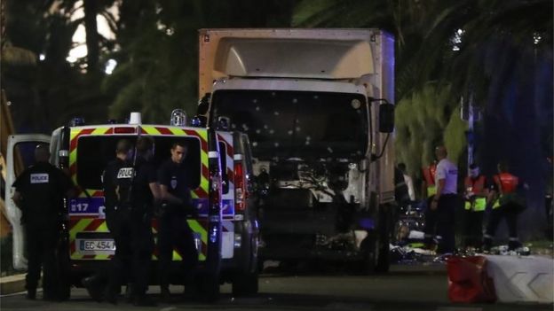 French police stand near the lorry that ploughed into crowds in Nice