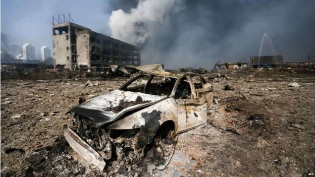 A damaged car is seen at the site of the massive explosions in Tianjin on August 13, 2015