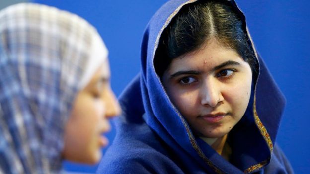 Malala Yousafzai (R) listens to 17 year old Syrian refugee Muzoon Almellehan speak to journalists at the City Library in Newcastle Upon Tyne, Britain December 22, 2015.