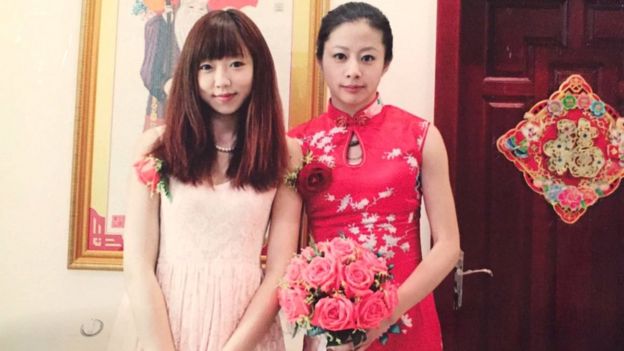 Ou Xiaobai (right) in her wedding photo