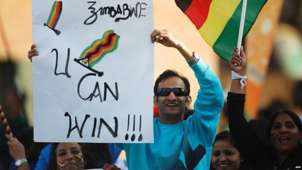 Zimbabwe supporters hold up banners during the second and final game in a series of two Twenty20 international cricket matches between Zimbabwe and India at the Harare Sports Club on July 19, 2015 in Harare