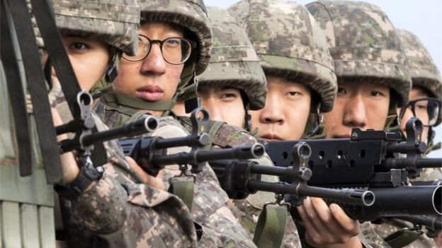 South Korean soldiers ride a military truck on the road leading to the truce village of Panmunjom in the border city of Paju on August 24, 2015.