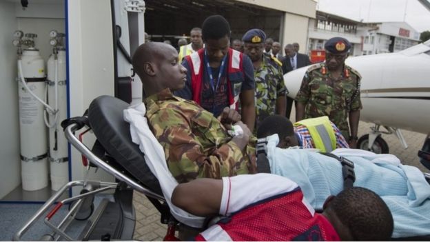 A Kenyan soldier, who Kenya Defence Forces said was injured in the attack by al-Shabab in Somalia earlier this week, is carried on a stretcher from the airplane to a waiting ambulance after being airlifted back to Nairobi for medical treatment, in Kenya Sunday, Jan. 17, 2016