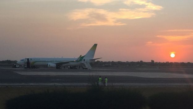 A plane sits on the runway at Banjul airport