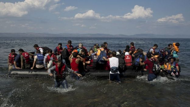 Migrants arrive on a dinghy after crossing from Turkey to Lesbos island, Greece. 8 Sept 2015