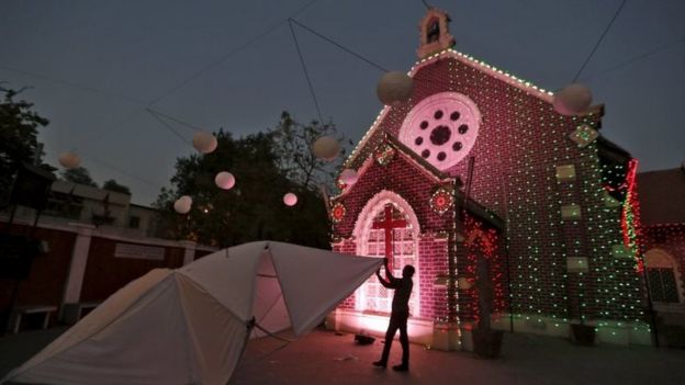 A craftsman works on a star to decorate a church ahead of Christmas in Ahmedabad