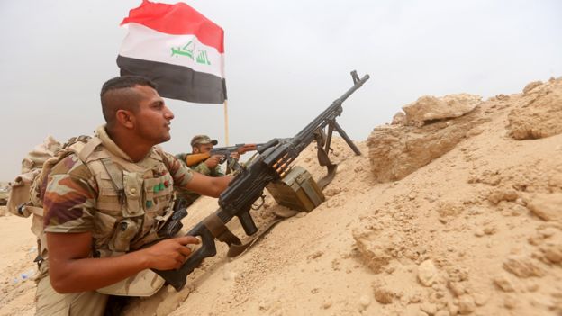 Shia fighters from the popular mobilisation units hold a position on the Tharthar frontline on the edge of Anbar province, 120km north-west of Baghdad, on June 1, 2015.
